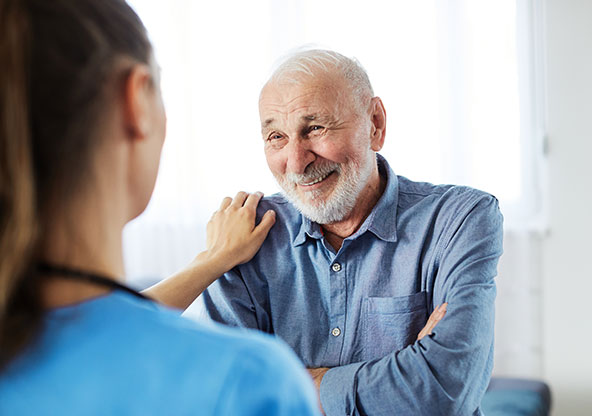A nurse comforts her patient