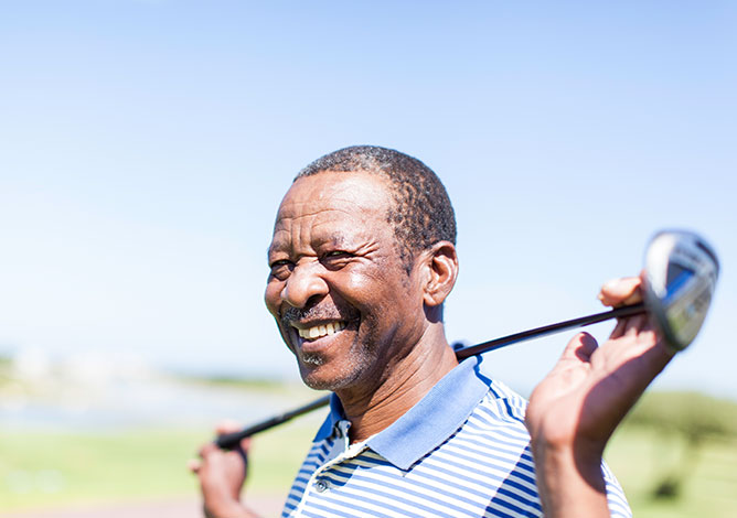 Golfer enjoying the course after joint injection and physical therapy. 